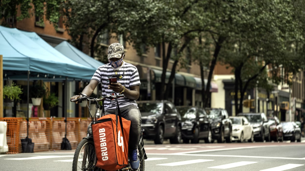 Grubhub bag on a delivery bike on a street in NYC. 