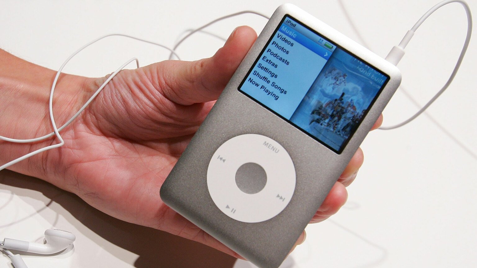 A close-up of a person holding an iPod Classic.