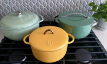 Three colorful Dutch ovens sitting on a stove