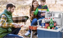 A family using the Knox Gear Electric Cooler And Warmer in the woods.