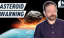 Text reading "asteroid warning" with host standing in front of asteroid 