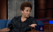 Wanda Sykes sitting on a couch being interviewed on "The Late Show with Stephen Colbert."