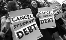 A black and white image of two protesters holding signs that read "Cancel Student Debt". 