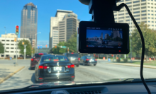 dash cam in front of windshield with view of street and cars