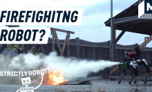 A Boston Dynamics Spot robot dog putting a fire out with a fire extinguisher.