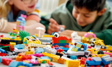 kids playing with legos on a table