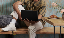 Person holding a Google Pixelbook Go Chromebook. 