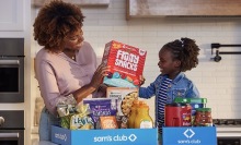 Family unpacking groceries from Sam's Club.