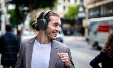 Man smiling in urban environment with Sony headphones