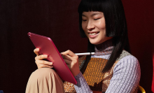 Woman using a red iPad Pro 