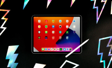 A tablet computer is currently being used and is kept on a dark surface
