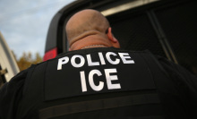 a U.S. Immigration and Customs Enforcement agent seen from behind
