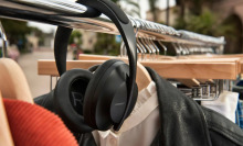 A pair of Bose headphones are lying on a coat hanger