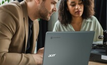 Man and woman sitting in front of gray Acer Spin 714 Chromebook