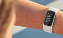Woman's wearing a white Fitbit on her wrist