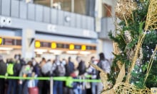 A Christmas tree in the foreground, and in the background, all the hassles of a busy airport
