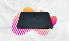 black macbook air with pink and yellow background
