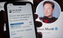 Elon Musk's Twitter poll asking if he should resign on a smartphone, in front of Musk's Twitter profile on a large screen.