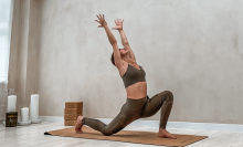 woman doing yoga pose on mat