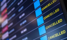 A board shows canceled flights at an airport