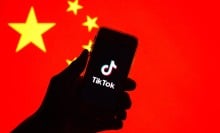 A phone with the TikTok logo in front of the Chinese flag