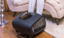 person sitting on the couch with feet in zyllion shiatsu foot massager 