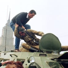 A pro-democracy demonstrator pulls a Soviet soldier from his tank in front of Moscow's White House 