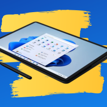 Microsoft Surface Laptop Studio in tablet mode and with stylus with a blue and yellow background.