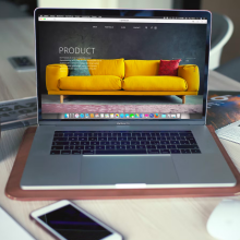 a macbook pro displaying the homepage of a work-in-progress furniture website