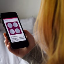 Woman looking up abortion pills on smartphone