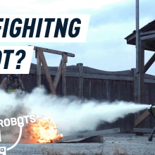 A Boston Dynamics Spot robot dog putting a fire out with a fire extinguisher.