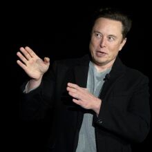 SpaceX and Tesla CEO Elon Musk speaking in front of a black background