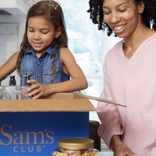 Mother and daughter unpacking groceries from Sam's Club.