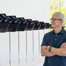 Apple CEO Tim Cook standing next to a line of MacBook Airs at an Apple store