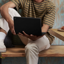 Person holding a Google Pixelbook Go Chromebook. 