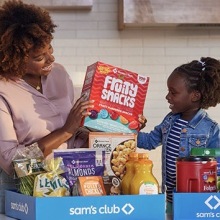 Family unpacking groceries from Sam's Club.