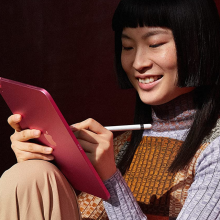 Woman using a red iPad Pro 