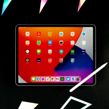 A tablet computer is currently being used and is kept on a dark surface