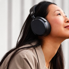Woman wearing Sennheiser Momentum 4 Wireless Headphones