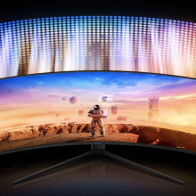 A wide gaming monitor is displaying an astronaut.