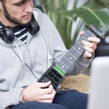 Person using the Jamstik® Guitar Trainer.