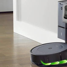 A smart vacuum robot in motion is lying in a room