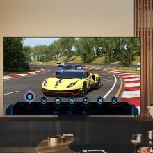 person playing car racing game on tv in living room 
