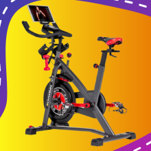 Exercise bike in front of sun yellow blob and purple background