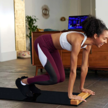 woman using brrrn board to exercise