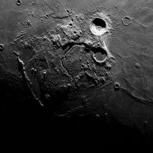 the moon's surface with a large crater