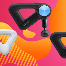 Three massage guns (one white, two black) against a pink and orange background