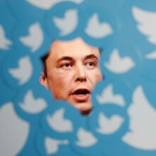 Elon Musk surrounded by Twitter logos.