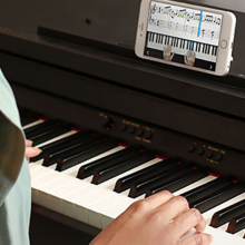 person playing piano with skoove app