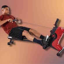 man in red shirt using rowing machine with colorful background